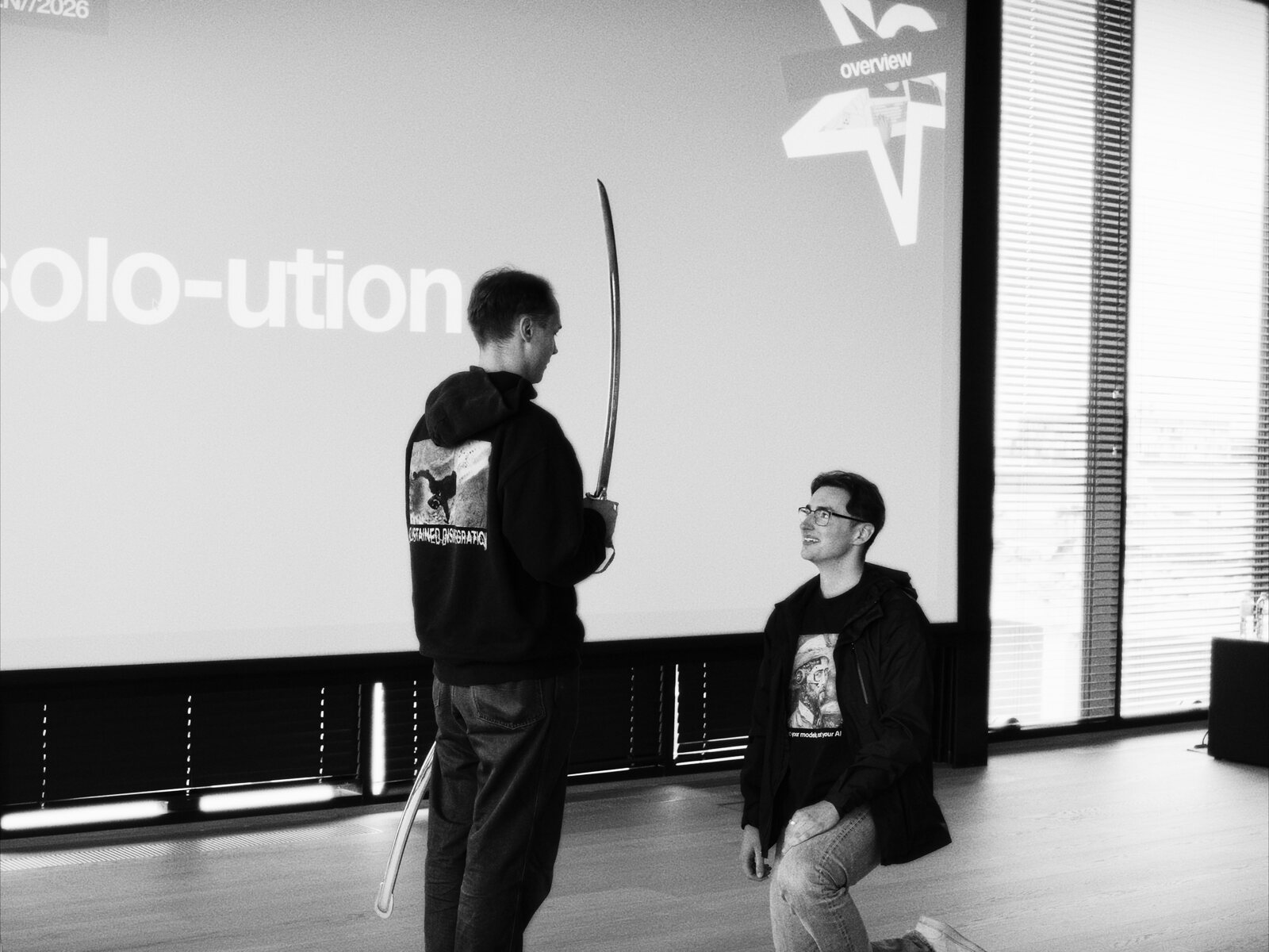 A kneeling basedhack builder is knighted with a saber in front of a 'solo-ution' slide.